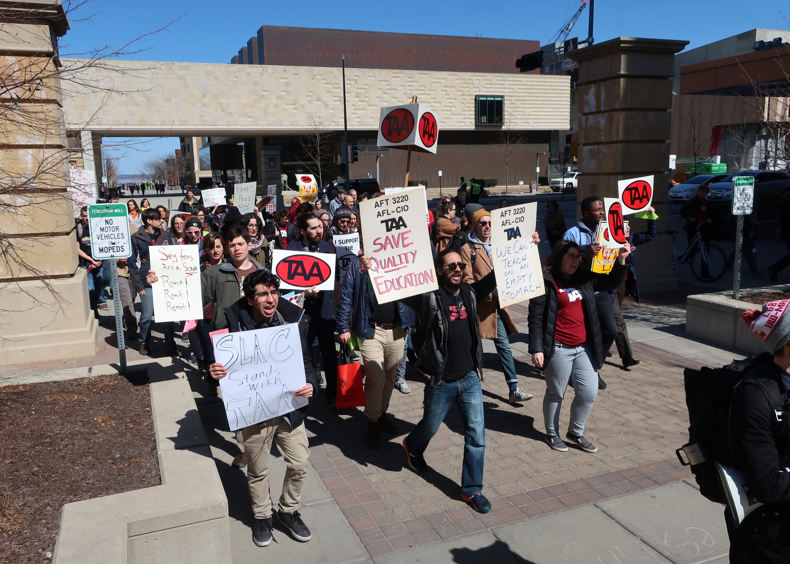 TAA members marching with anti-mandatory-fee signs