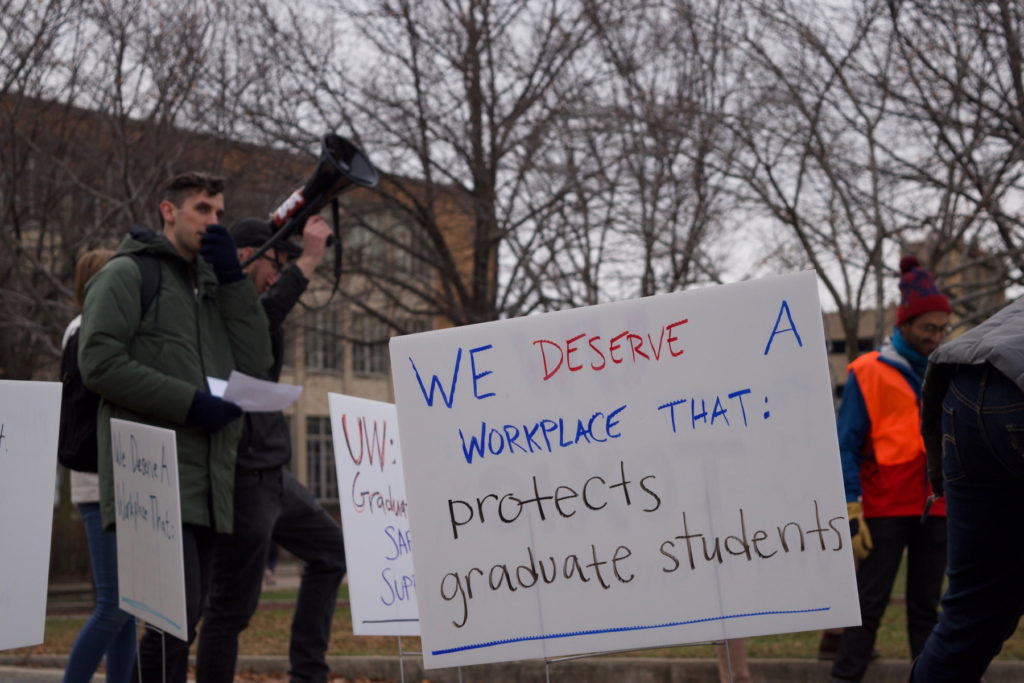 December 2019 rally. Photograph of a sign reading "We deserve a workplace that protects graduate students"